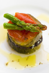 eggplant with zucchini, tomato, asparagus and pepper on white dish
