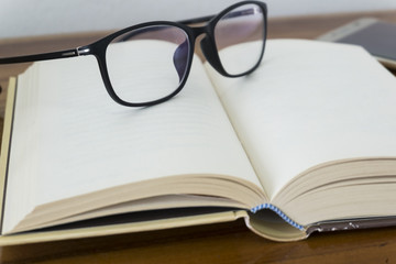 Close up glasses on the book