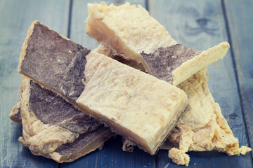 dry salted cod fish on blue wooden background