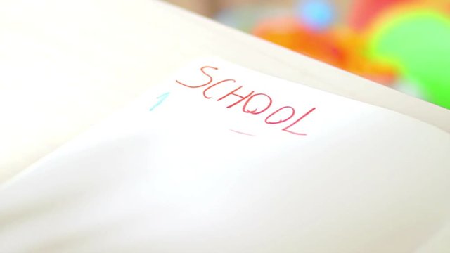 Child writing numbers on exercise book. Using pencil with various colors. Numbers 1 to 3