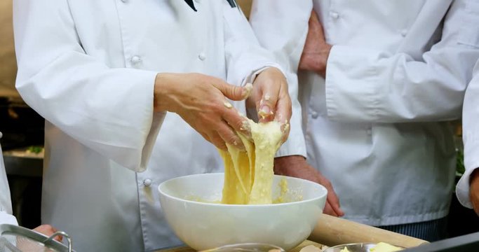 Chef making dough in commercial kitchen