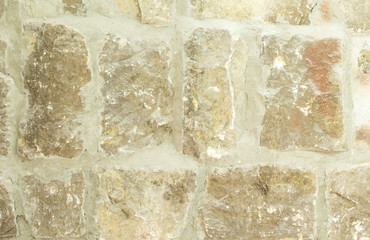 Old moldy stone wall with concrete.