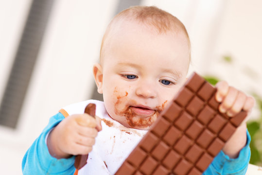 Baby boy eating chocolate