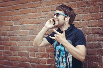 Bearded  young stylish hipster man speak by phone