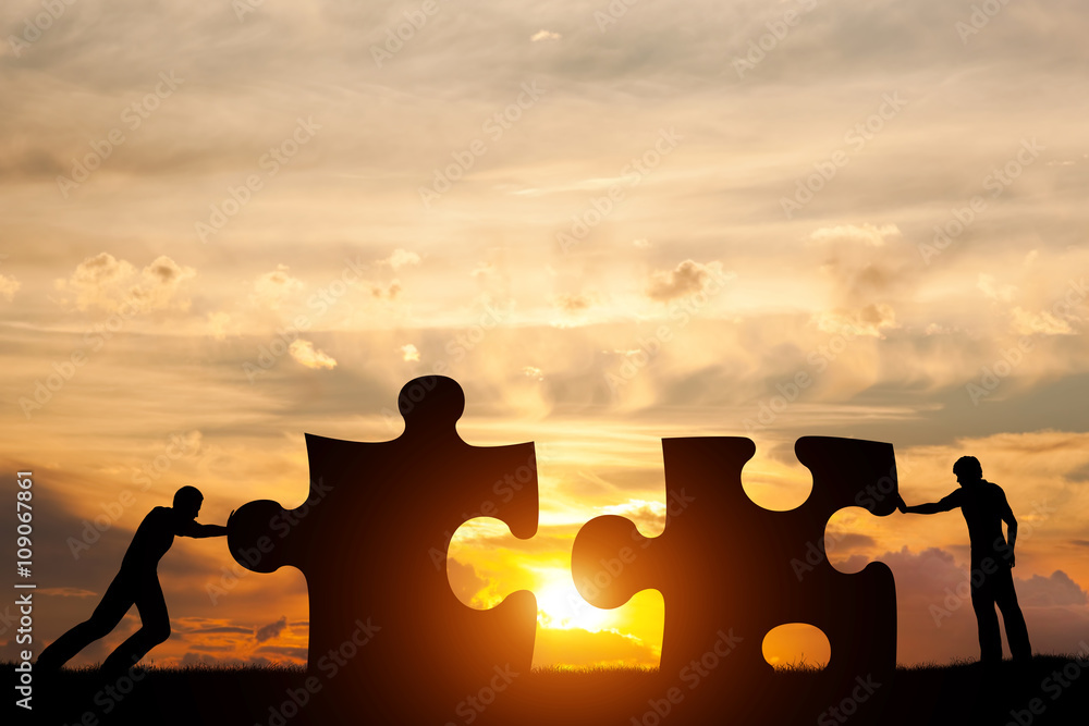 Wall mural two men connect two puzzle pieces. concept of business solution, solving a problem.