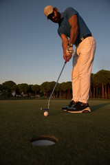 Fototapeta premium golfer hitting shot at golf course