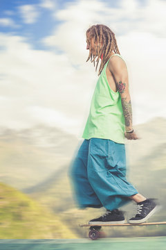 Portrait of cool, funny handsome man with skateboard