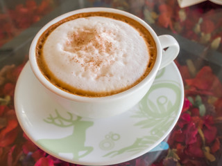 Close up white cup of Coffee, latte on the wooden glasses table