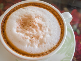 Close up white cup of Coffee, latte on the wooden glasses table