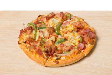 Pizza with sliced vegetables on wood