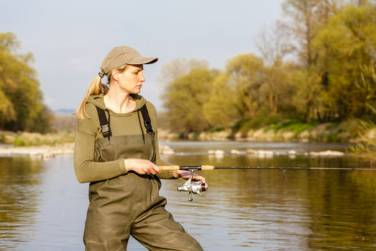 woman fishing in the river in spring