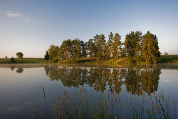 Fototapeta na wymiar Sunset landscape over the tranquil lake