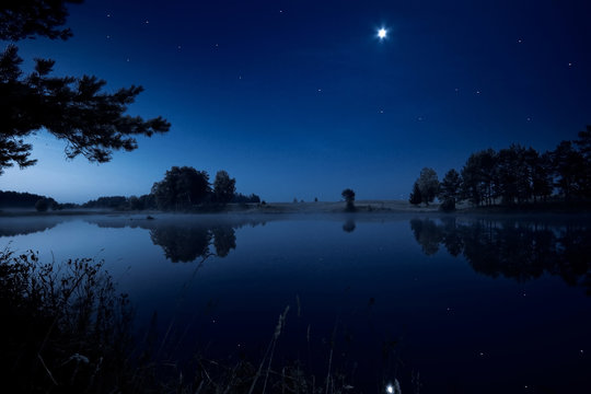Moon rising over lake