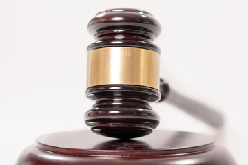 judge gavel / judge gavel over a grey background