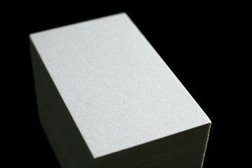 Blank white business cards on a black background. Photo mock-up.