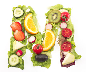 Letter M made of salad and fruits