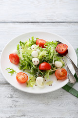  salad with tomatoes on white plate