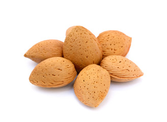 Heap of fresh almonds in shells isolated on white background