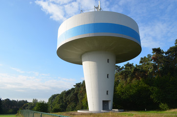 Blue and white mushroom-shaped water tower in meadow in natural area in Flanders