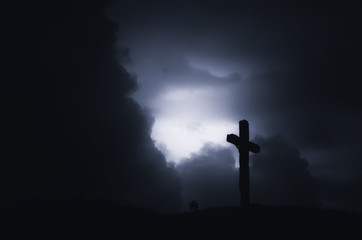 Cross silhouette on dramatic sky during storm