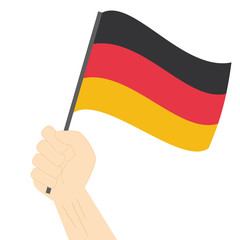Hand holding and raising the national flag of Germany
