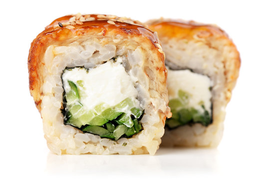 Sushi rolls with cream cheese, nori and cucumber covered with eel