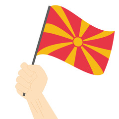 Hand holding and raising the national flag of Macedonia