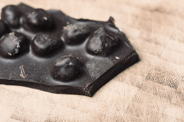 Chocolate nuts piece on a wooden background