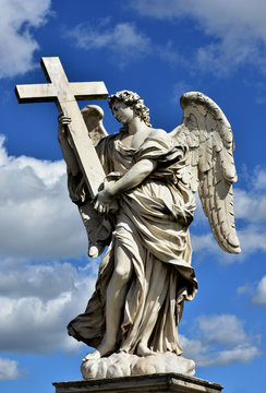 Angel with the Holy Cross and beautiful sky, Marble statue from Sant'Angelo bridge monumental balustrade in the center of Rome