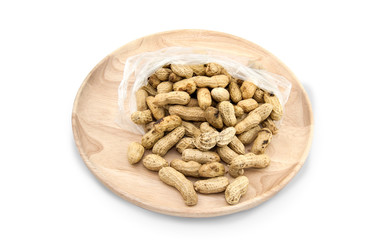 Wooden dish of nuts on white wooden background