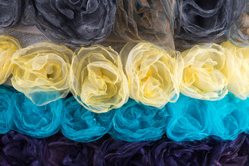 Background of different colors of cloth flowers