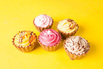 Chocolate cupcakes with yellow backgroud
