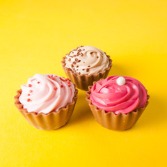 Chocolate cupcakes with yellow backgroud