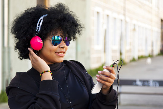 girl listening to music on the street