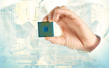 Man holding microchip and electronic circuit board, close up
