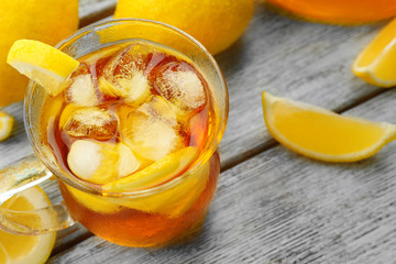 Glass of ice lemon tea on wooden table