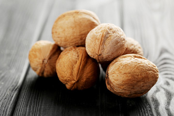 Walnuts on a black wooden table