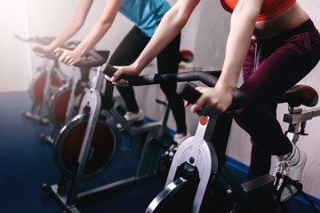 Woman on fitness exercise bike at indoor - 109081006