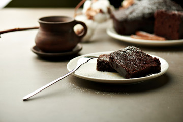 Tasty chocolate cake and cotton flowers