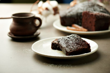 Tasty chocolate cake and cotton flowers