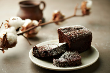 Tasty chocolate cake and cotton flowers