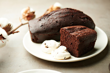 Tasty chocolate cake and cotton flowers