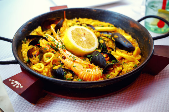 Typical spanish seafood paella in pan