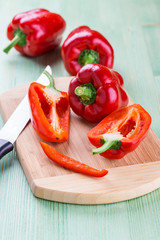 Fresh organic bell peppers on a wooden board