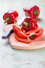 Fresh organic bell peppers on a wooden board