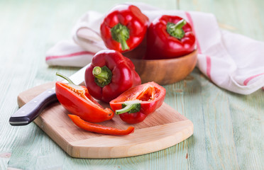 Fresh organic bell peppers on a wooden board