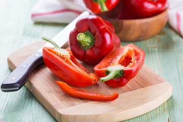 Fresh organic bell peppers on a wooden board