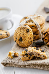 Cookies with chocolate on a table for dessert. Fresh biscuits with coffee for breakfast. Close-up.