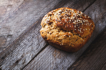 Freshly baked homemade bread on rustic wood background