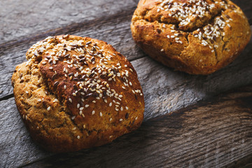 Freshly baked homemade bread on rustic wood background